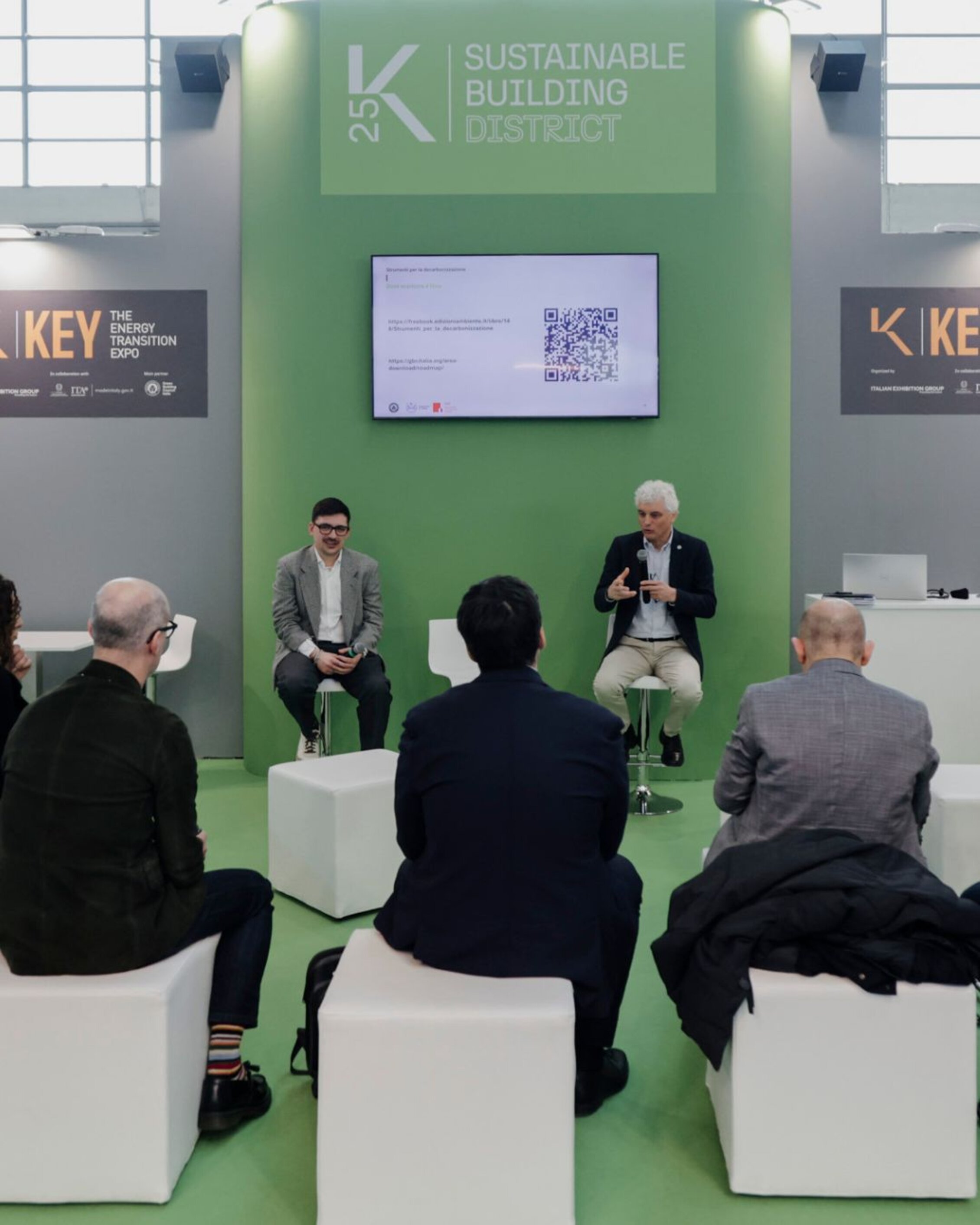 two speaker talking during a conference at the sustainable building district
