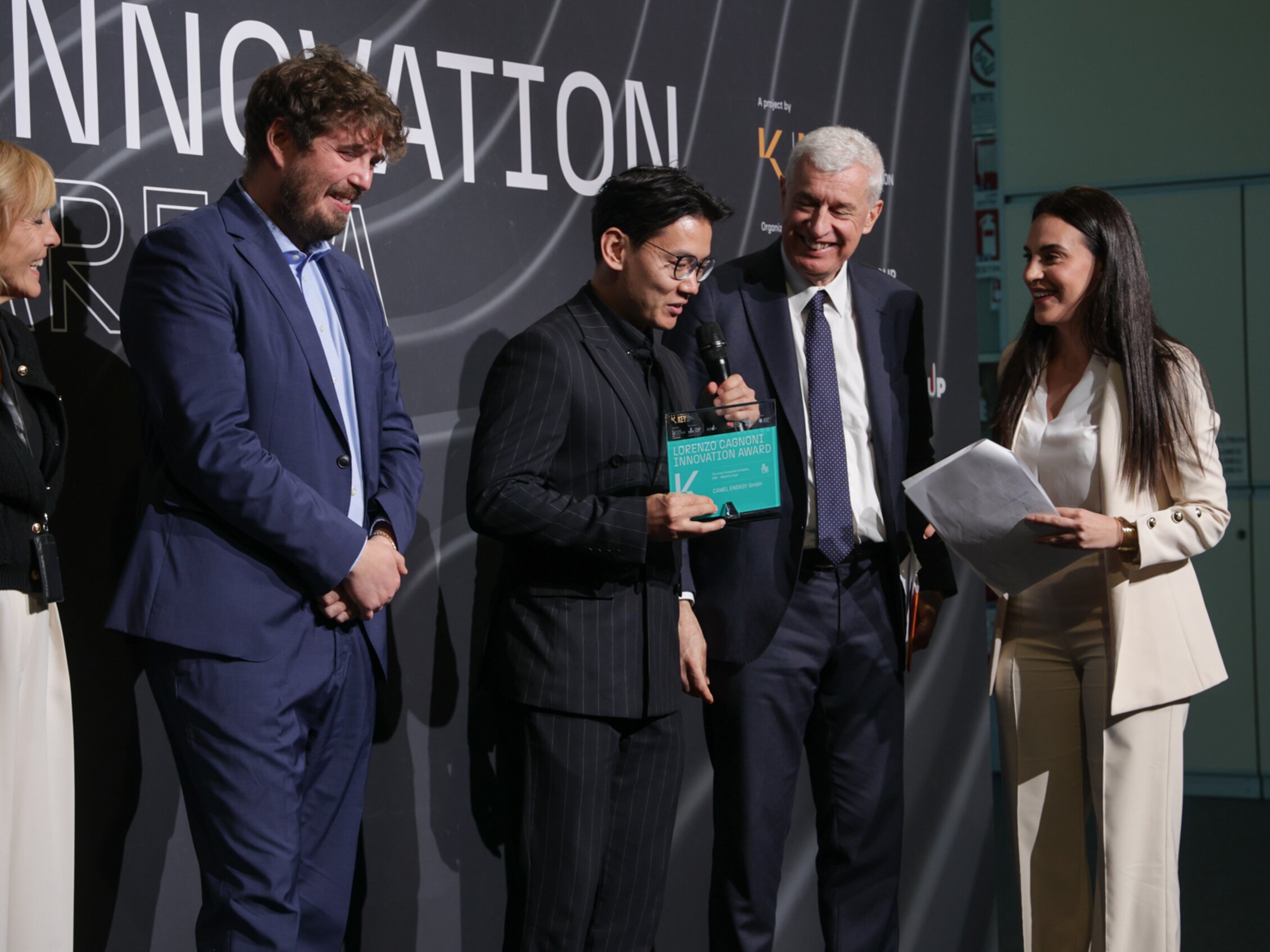 Lorenzo Cagnoni Innovation Award winner speaks into the microphone on stage